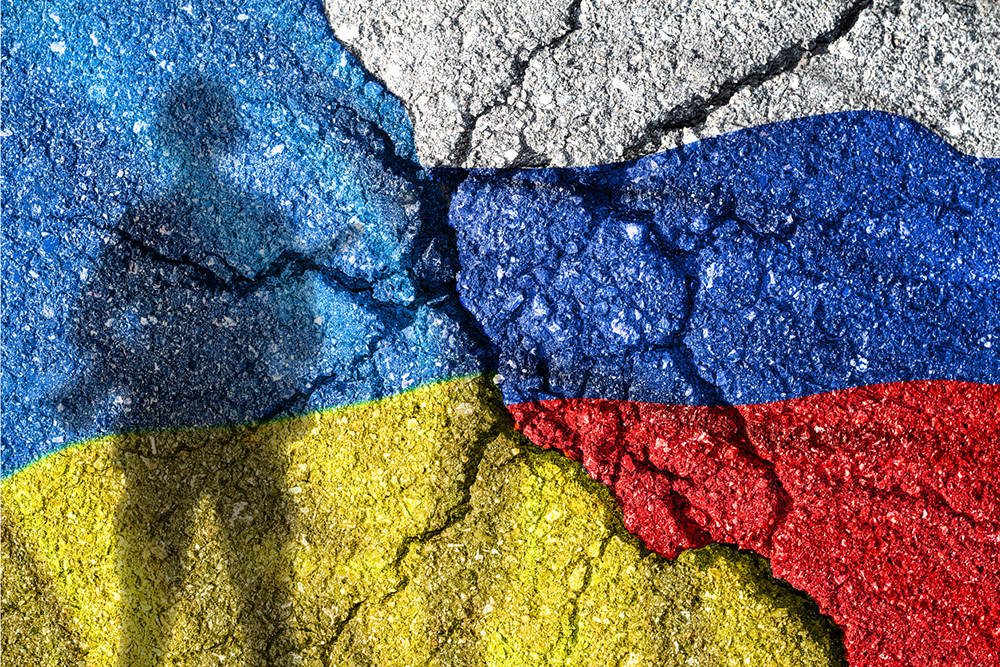 Image of cracked pavement with colors of the Russia and Ukraine flags